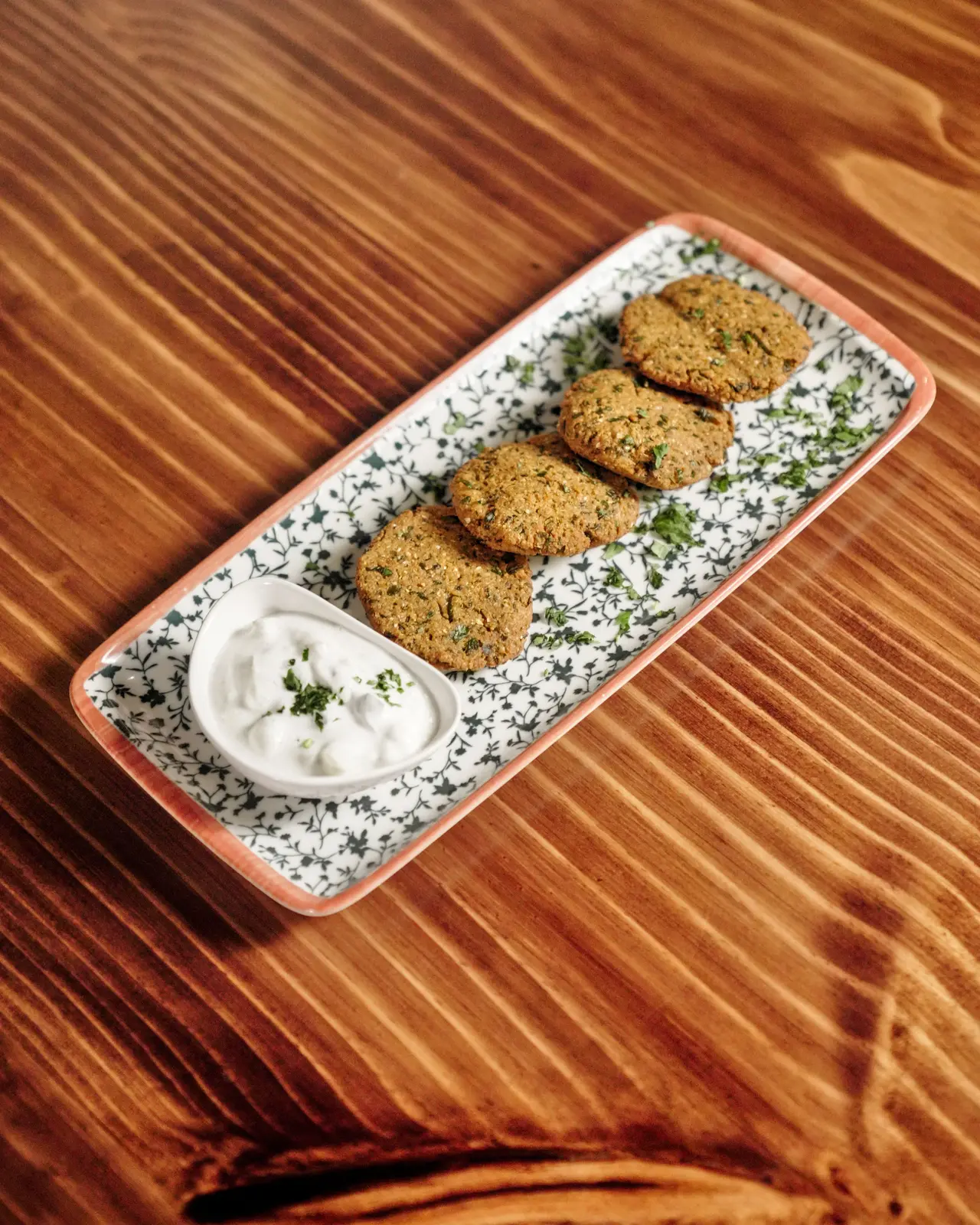 Falafel with a yogurt dip on a long plate