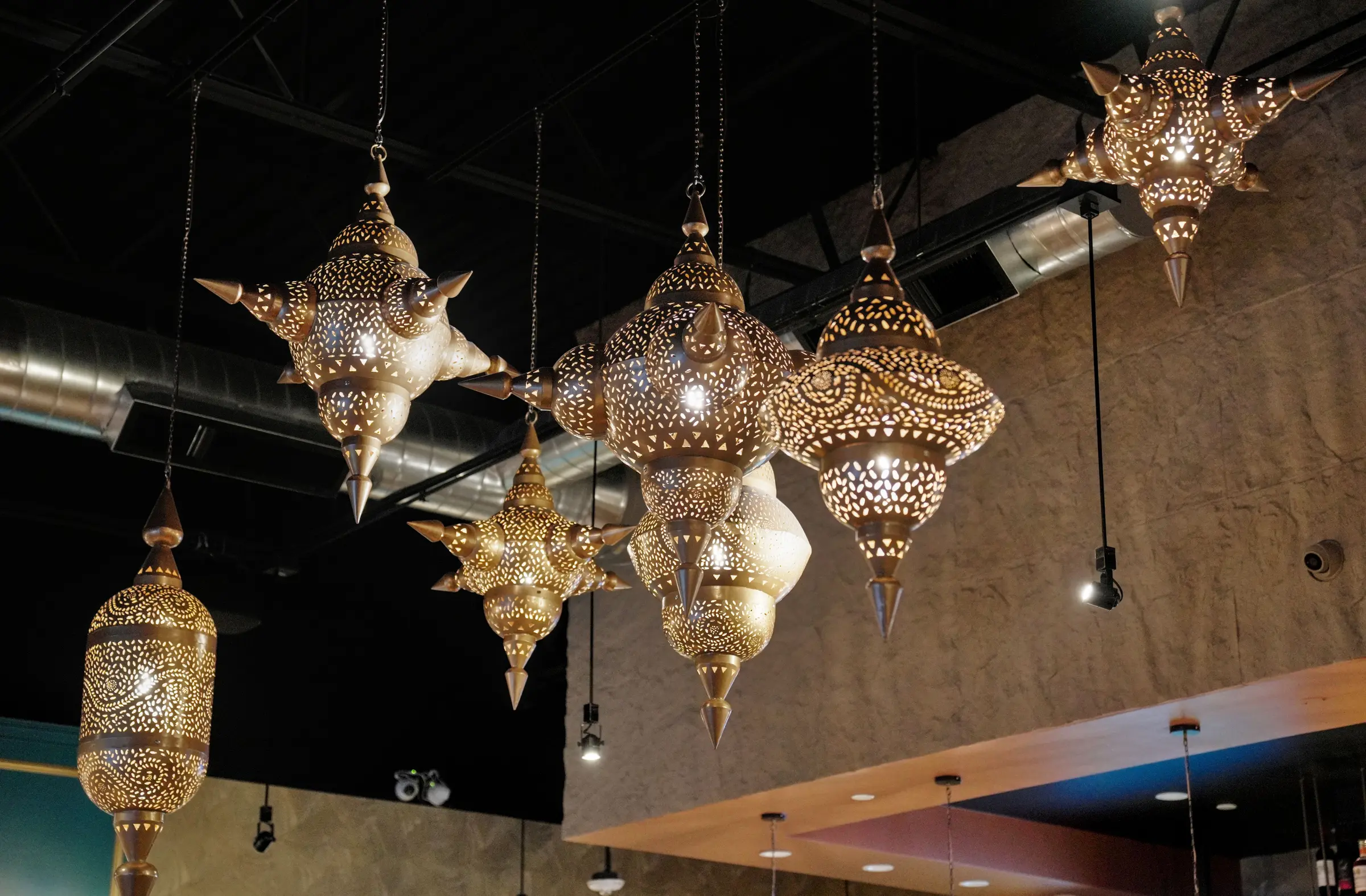 Pierced brass lanterns hanging over the dining room