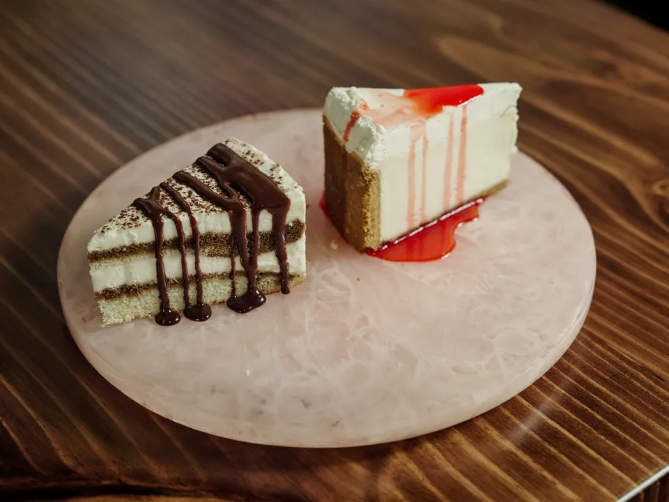 Cheesecake and tiramisu on a stone plate