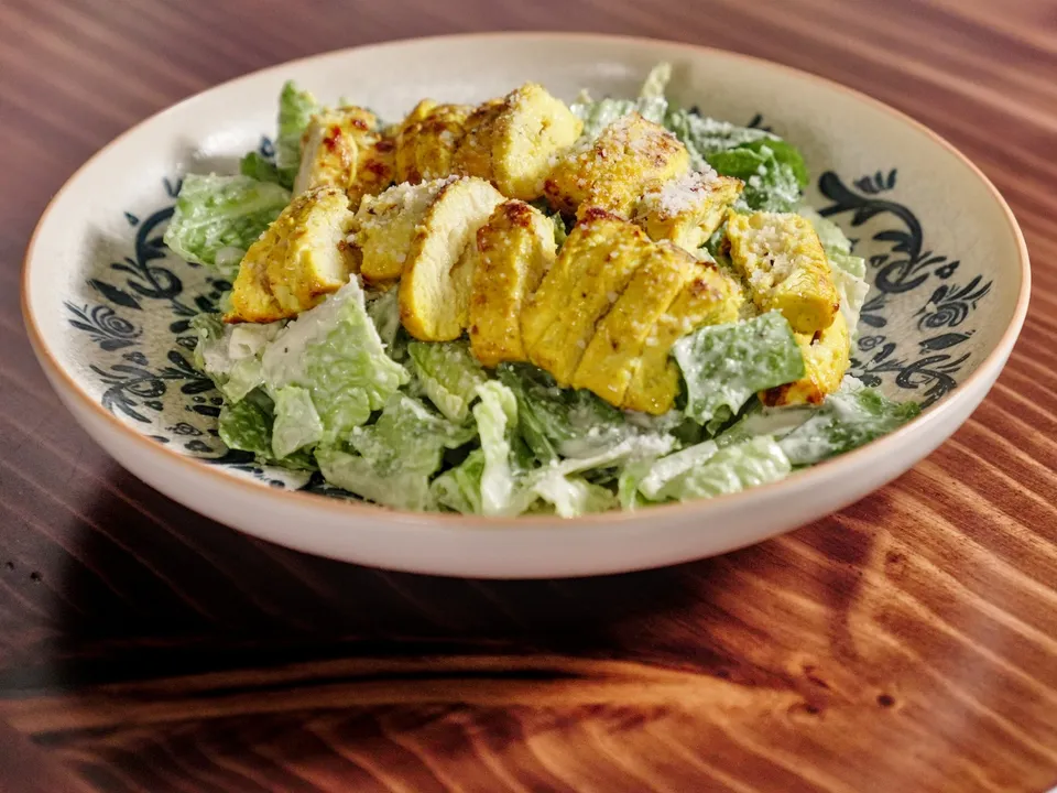 Caesar salad topped with grilled chicken