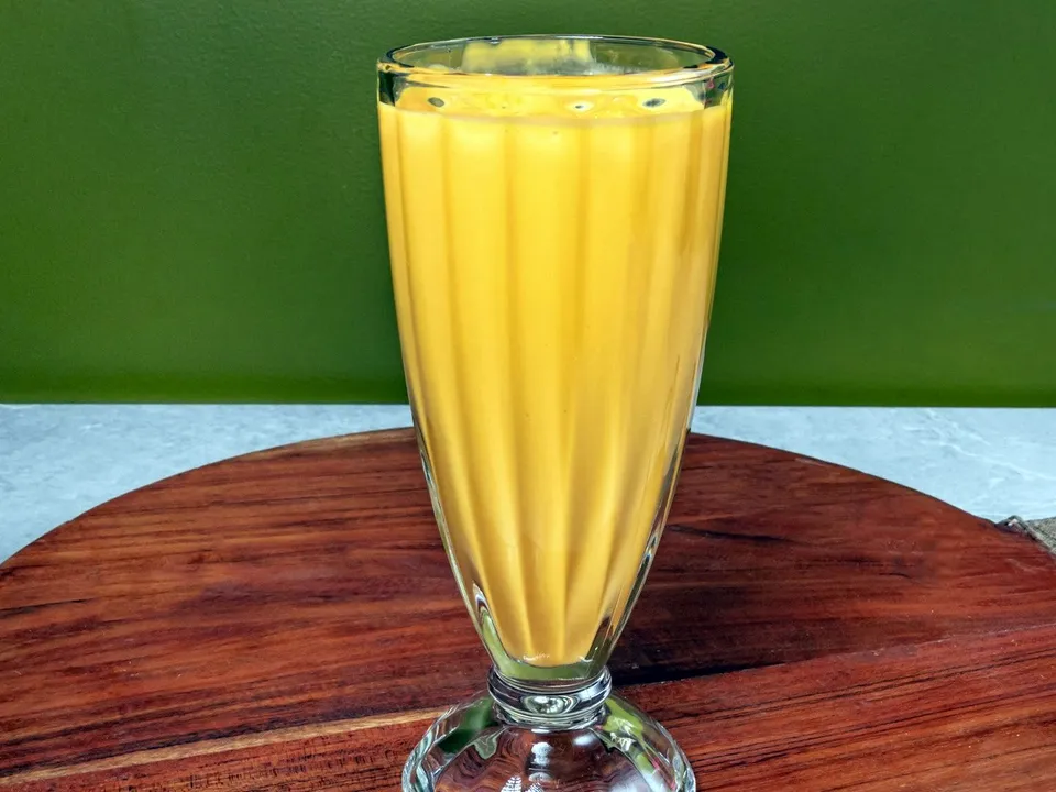 A tall glass of mango lassi