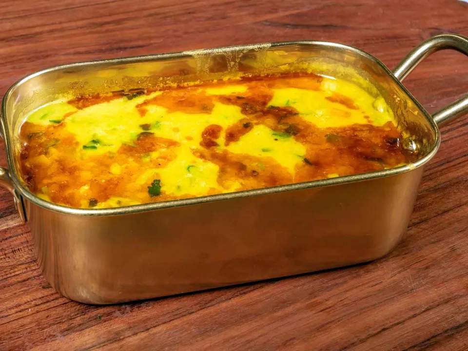Dal tadka in a brass dish