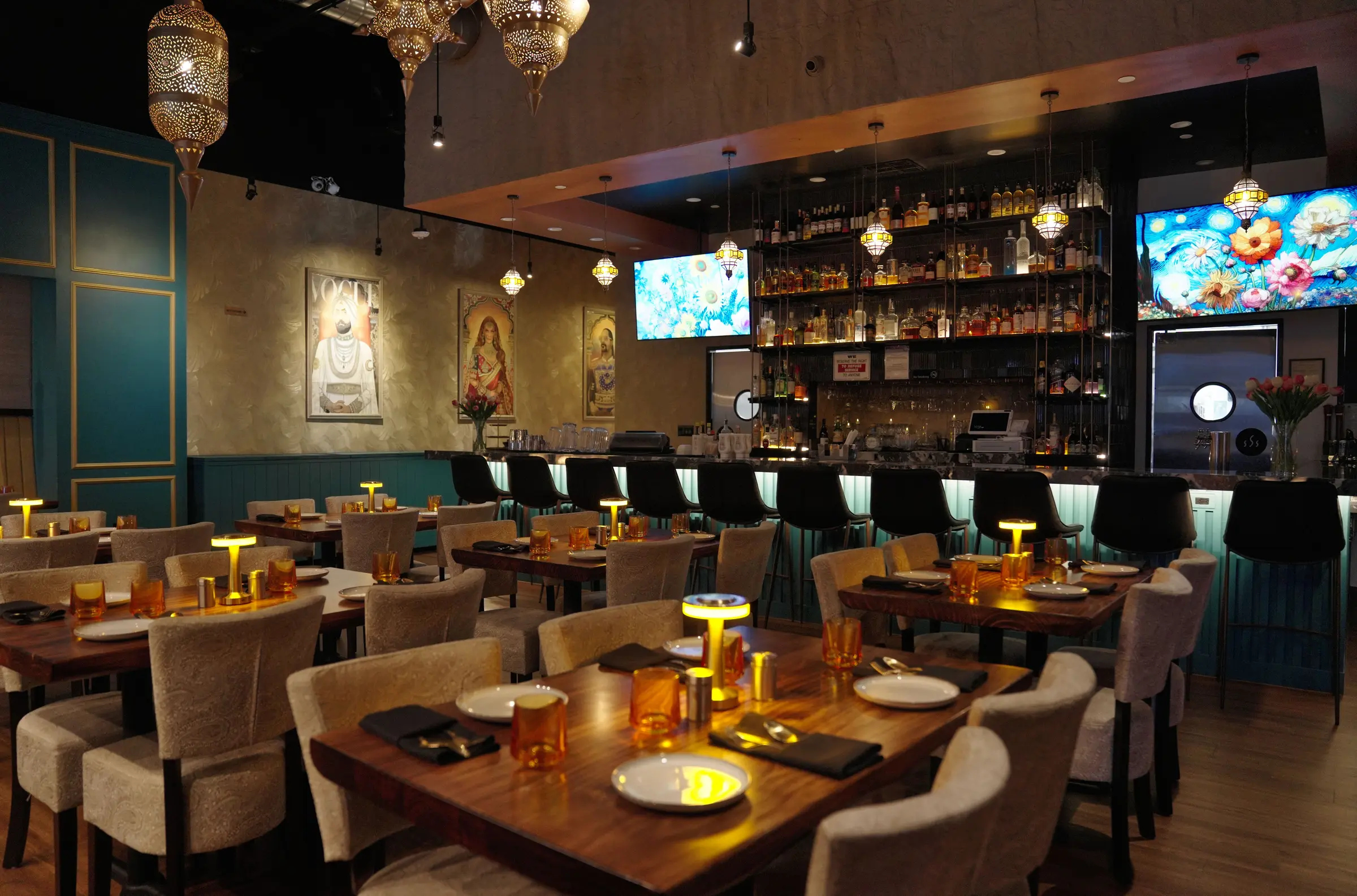The dining room at Kebab & Kurry, teal banquettes and brass lanterns